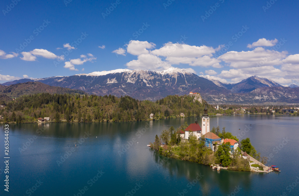 Bled, Slovenia - 04 19 2019: Lake Bed in Slovenia with Alps covered with snow in the background.