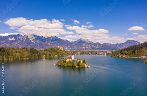 Bled, Slovenia - 04 19 2019: Lake Bed in Slovenia with Alps covered with snow in the background. © Indoor Vision