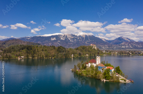 Bled, Slovenia - 04 19 2019: Lake Bed in Slovenia with Alps covered with snow in the background. © Indoor Vision