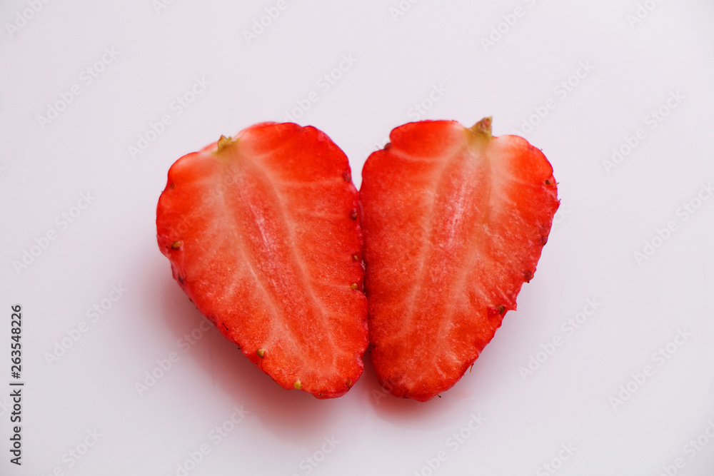 Cut in half berry juicy fresh tasty strawberries on a white plate Cut in half berry juicy fresh tasty strawberries on a white plate