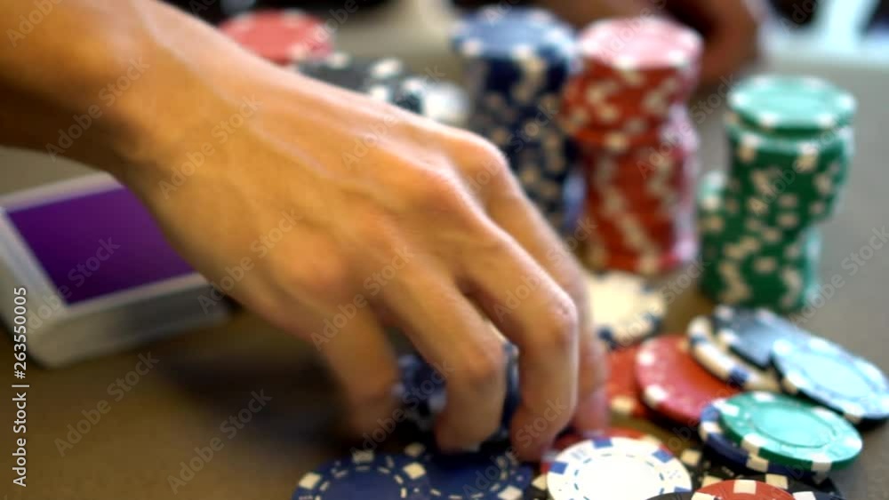 picking up poker chips at gambling table with playing cards picking up poker chips at gambling table with playing cards