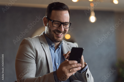 Mid adult man reading a text message on mobile phone