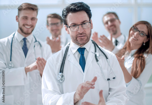 successful doctor  accepting congratulations from colleagues