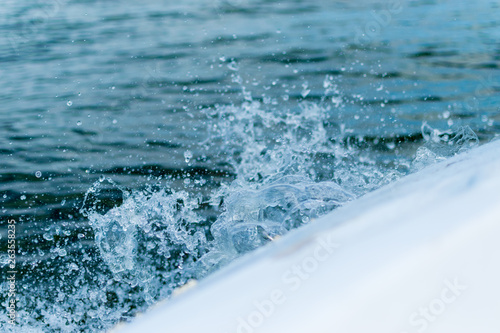 Splashing water from the edge of the boat.