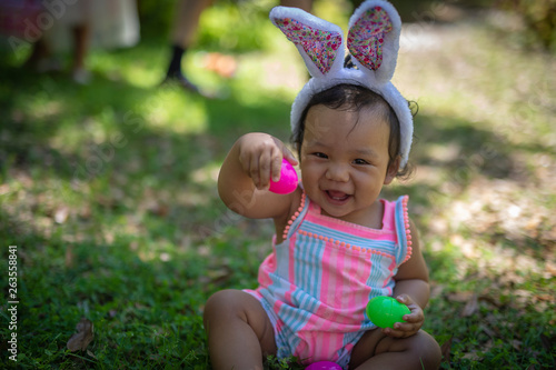 Baby girl with easter eggs