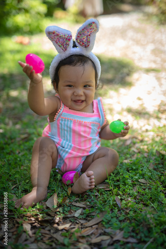 Baby girl with easter eggs