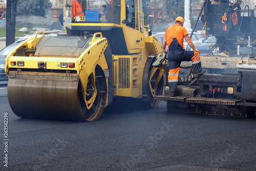 Laying asphalt with a paver on city road