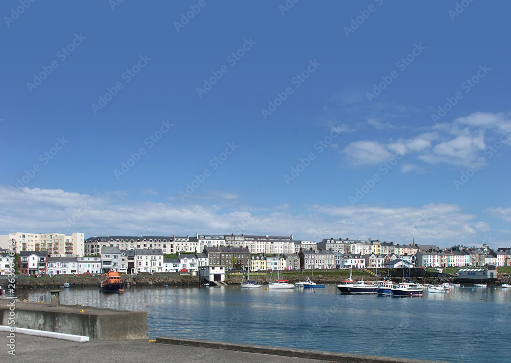 Houses in the harbour by the irish sea Co. Antrim Northern Ireland 2017 with  blue sky background for editors text copy