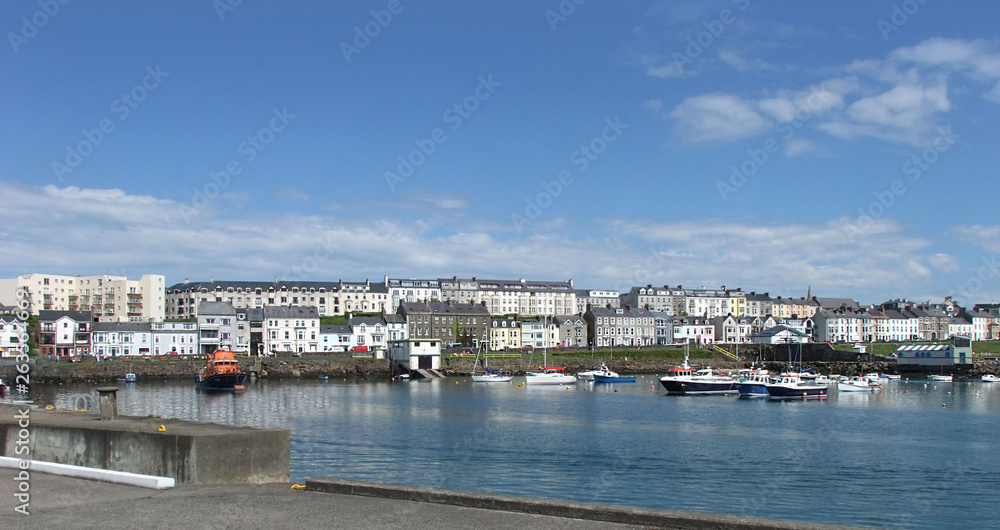 Houses in the harbour by the irish sea Co. Antrim Northern Ireland 2017 with  blue sky background for editors text copyaa