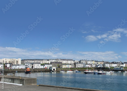 Houses in the harbour by the irish sea Co. Antrim Northern Ireland 2017 with blue sky background for editors text copy