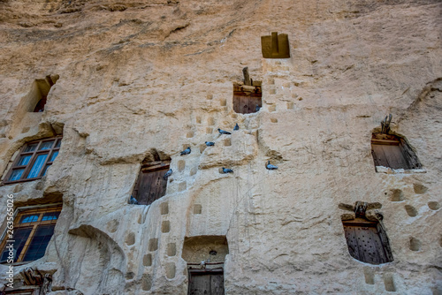 An ancient tradition, naturally cool stone carved warehouses along with many pigeon lofts in Ermenek, Turkey photo