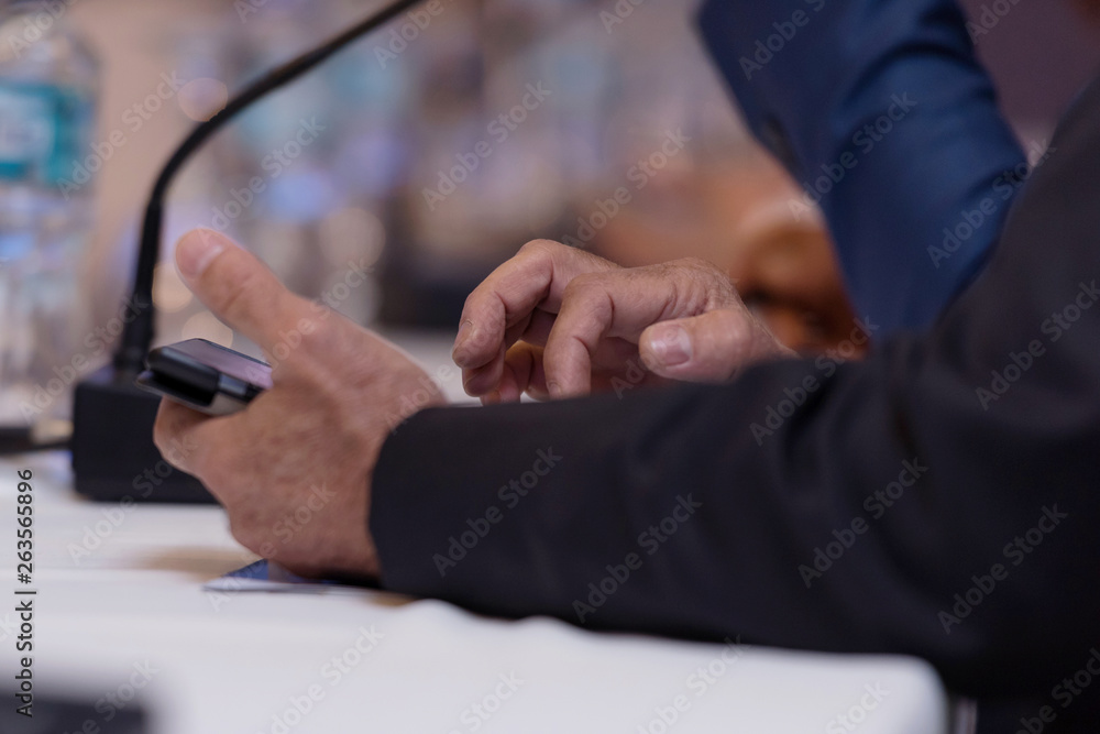 Young businessman at business conference room with public giving presentations. Audience at the conference hall. Entrepreneurship club. Young businessman at business conference room with public giving presentations. Audience at the conference hall. Entrepreneurship club.