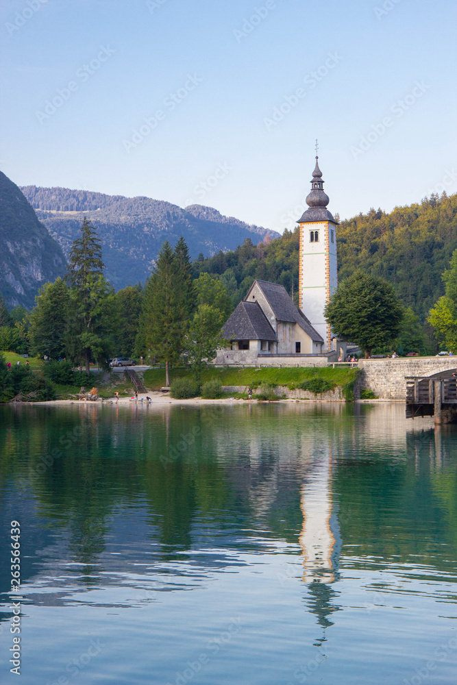 Bohinj Lake, Church of St John the Baptist with bridge. Triglav National Park, Julian Alps, Slovenia