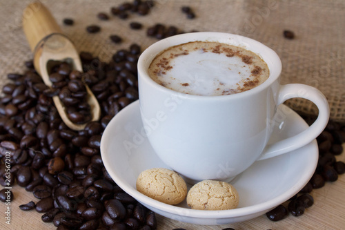 Coffee cup with italian amarettini cookies and fresh coffee beans. © Anabel