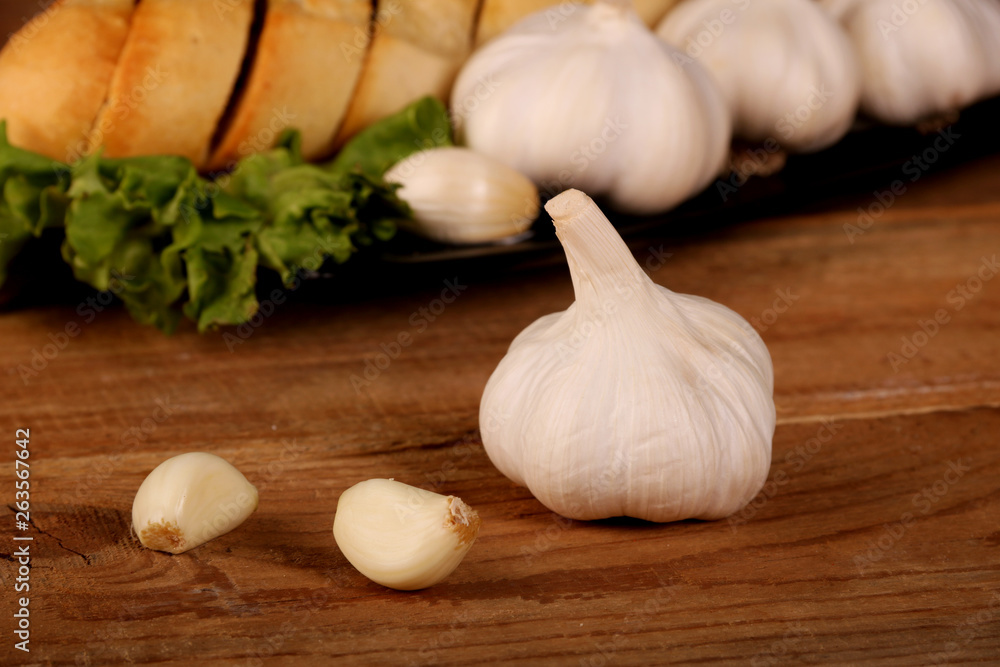 Tasty bread with Garlic. sliced garlic, garlic clove, garlic bulb, on kitchen wooden table Tasty bread with Garlic. sliced garlic, garlic clove, garlic bulb, on kitchen wooden table