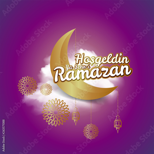 crescent moon and calligraphy inscription which means '' Hosgeldin Ya Sehri Ramazan'' on night cloudy background. translation: Ramadan Kareem greeting card decorated with arabic lanterns. photo