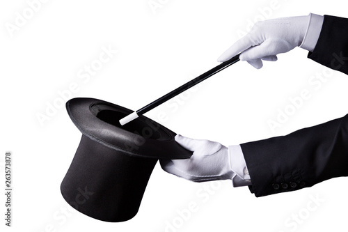 Fotografie magician holding his hat and wand isolated on white