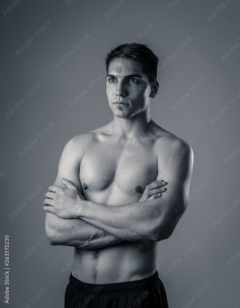 Fototapeta premium Portrait of strong healthy handsome Athletic man isolated on neutral background
