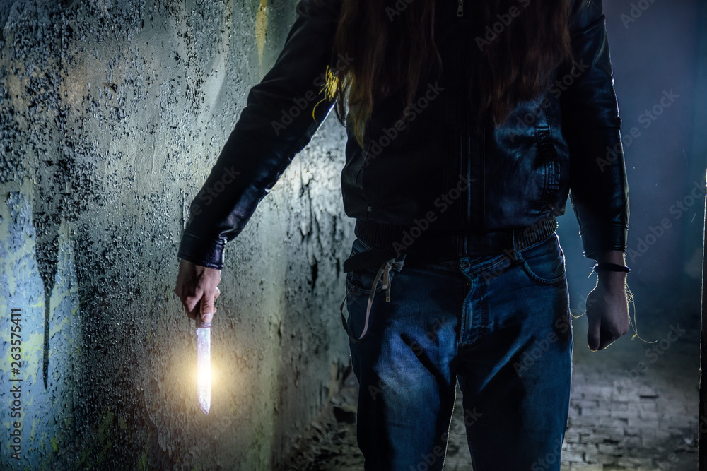 Maniac killer with knife in hand, close up Maniac killer with knife in hand, close up