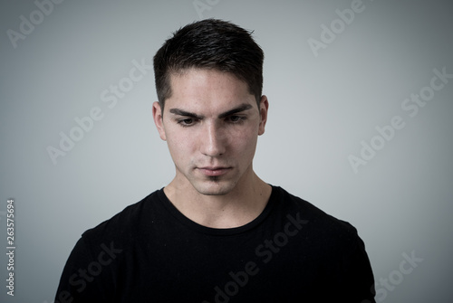 Portrait of sad and depressed young man feeling upset. Human expressions and negative emotions