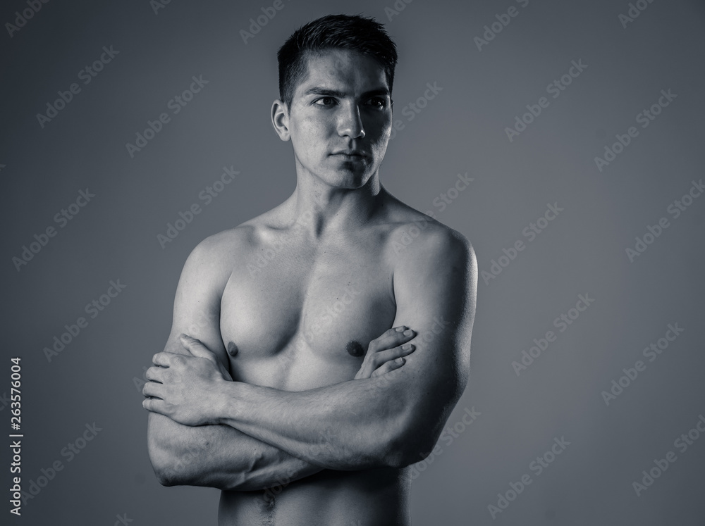 Half length portrait of strong healthy handsome Athletic man isolated on neutral background Half length portrait of strong healthy handsome Athletic man isolated on neutral background