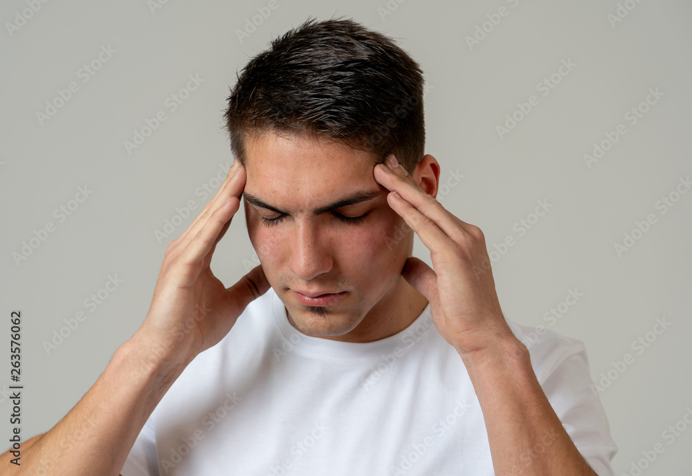 Naklejka premium Young attractive man in pain with headache suffering migraines.