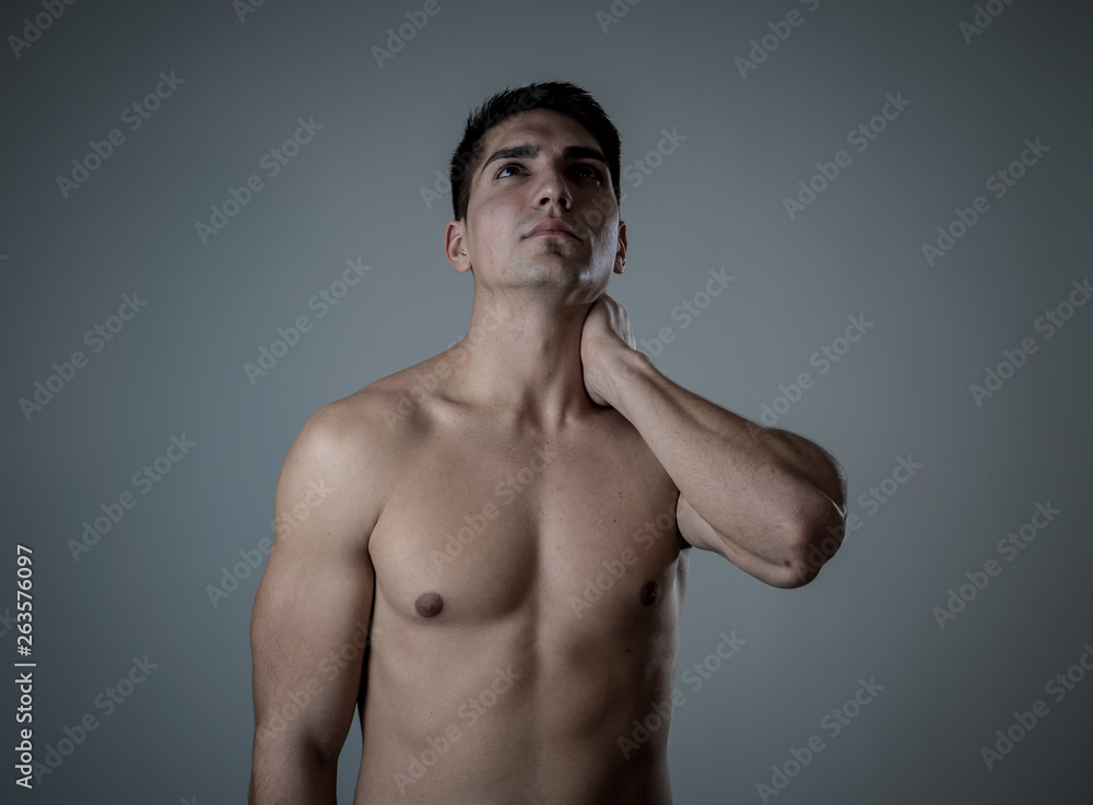 Fototapeta premium Strong young man suffering neck and cervical pain