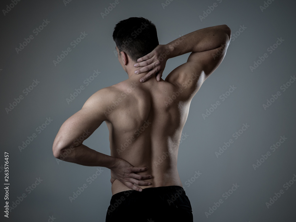 Fototapeta premium Body Pain. Strong young man suffering neck and back pain