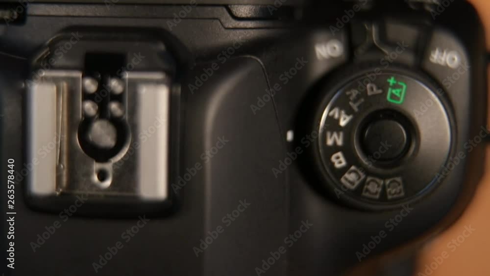 Womens hand turning on dslr camera. DSLR camera switches and buttons turned on. Womens hand turning on dslr camera. DSLR camera switches and buttons turned on.