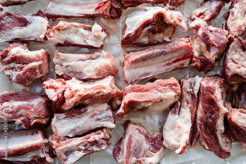 Raw pork ribs chopped in pieces on the white table high angle view