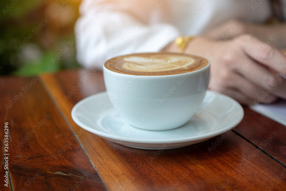 People are drinking a latte in a coffee shop. People are drinking a latte in a coffee shop.