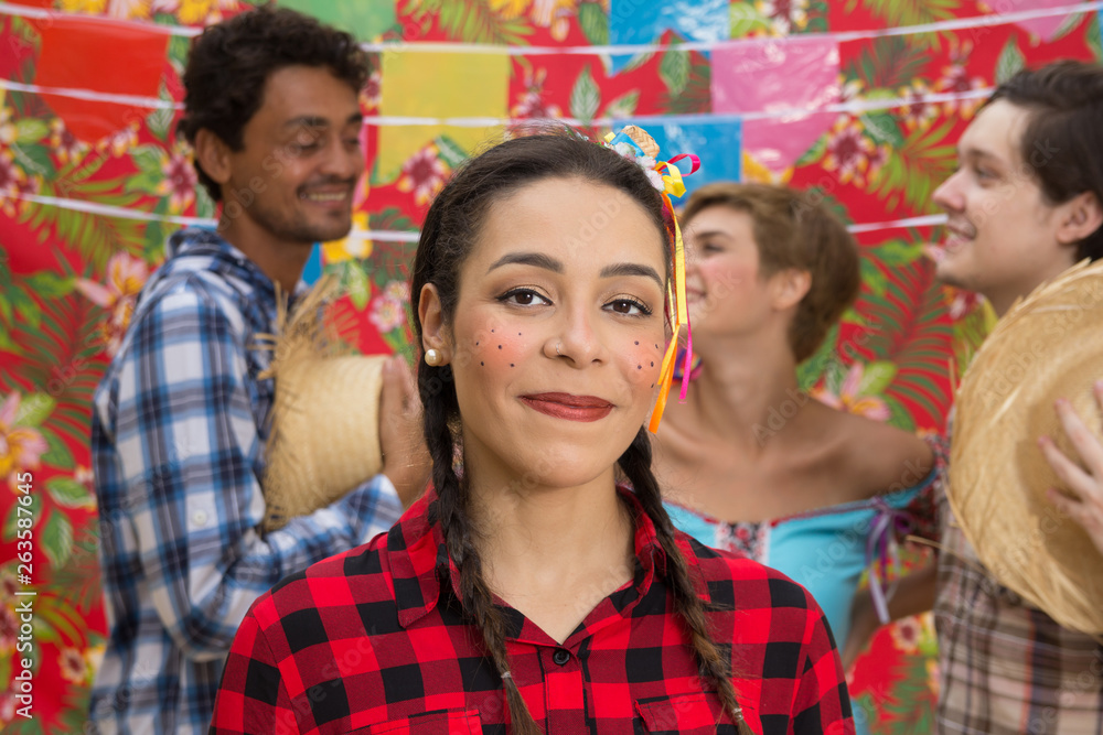 Festa Junina: June Party. People in plaid costume at traditional holiday.  Flags and decor in background. Stock Photo | Adobe Stock