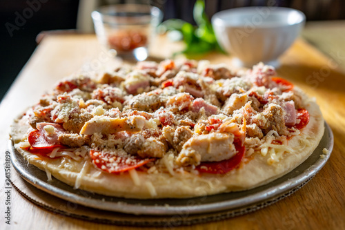 Pizza with ingredients on a cutting board