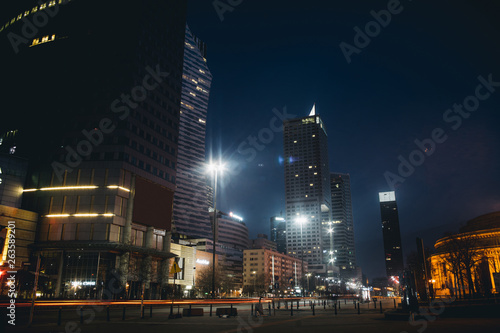Nightly Warsaw skyscrappers with blurred transport on streets