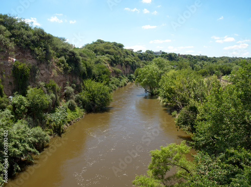 Suquía river (also know as Río Primero) running through a neighborhood in Cordoba City, Cordoba, Argentina.
