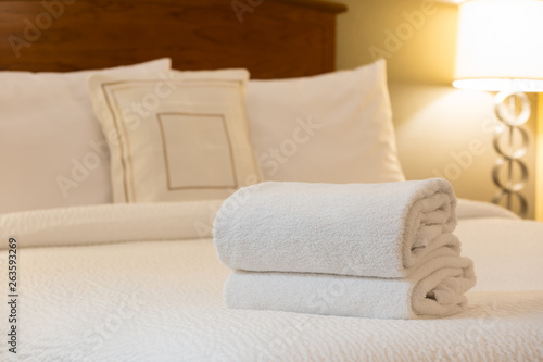 White towel on bed in hotel room © Kenishirotie