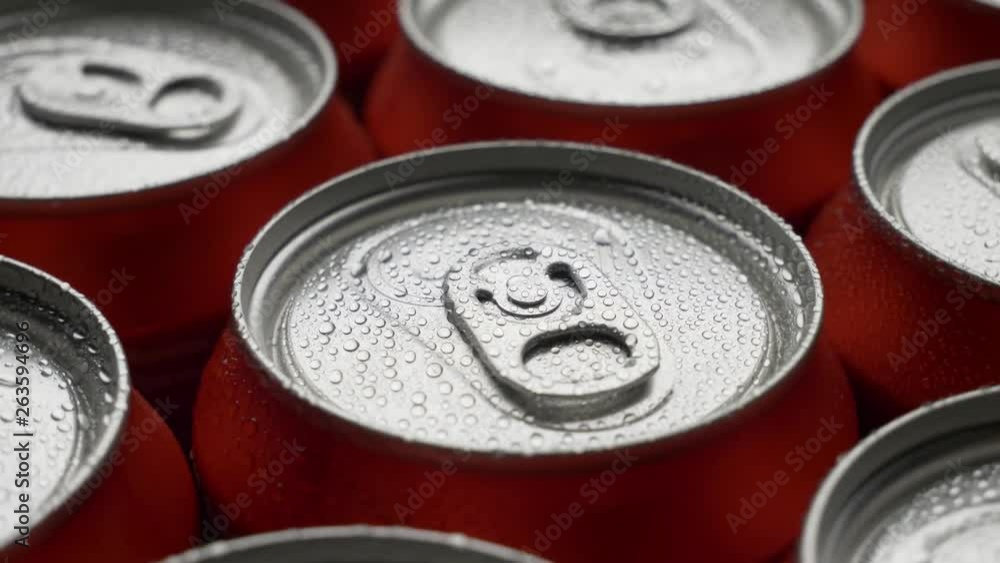 top view water droplets on red can of soda or beer rotate background. Slow motion video dolly crane shot medium extreme close up panorama high angle telephoto lens top view water droplets on red can of soda or beer rotate background. Slow motion video dolly crane shot medium extreme close up panorama high angle telephoto lens
