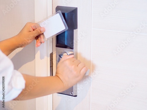 Security system is a door with a key card. The woman's hand is going to be the door using a key card.