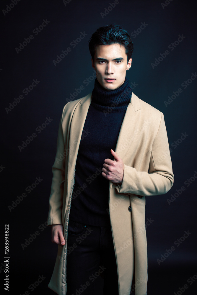 handsome asian fashion looking man posing in studio on black background, lifestyle modern people concept