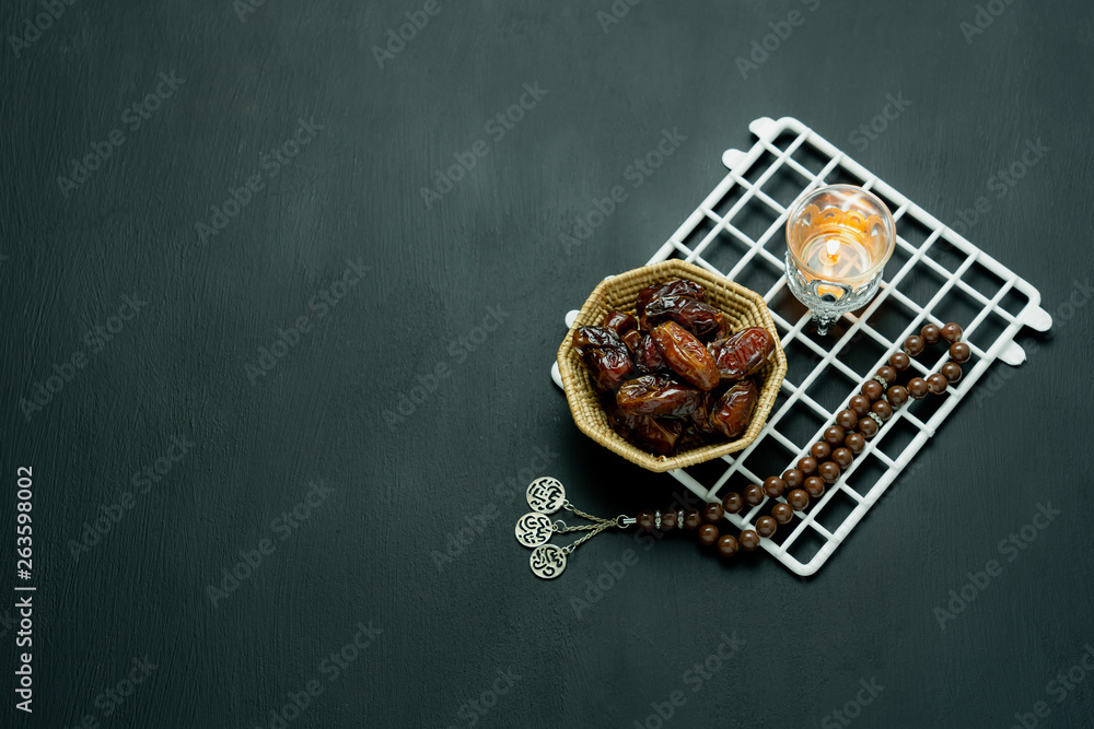 Table top view aerial image of decorations Ramadan Kareem holiday background.Flat lay arrangement dates with brown rosary & lighting.Halal meal set for fasting is obligatory for Muslim on wooden. Table top view aerial image of decorations Ramadan Kareem holiday background.Flat lay arrangement dates with brown rosary & lighting.Halal meal set for fasting is obligatory for Muslim on wooden.