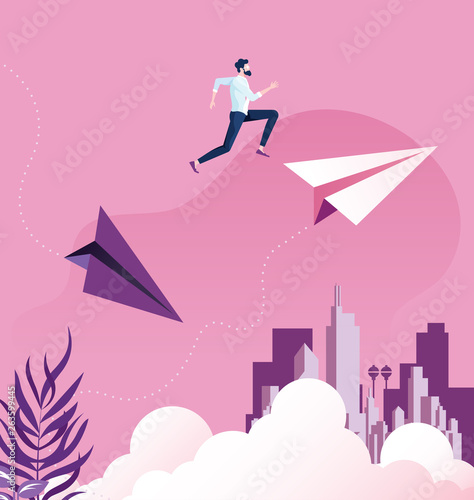 Businessman jumping between paper planes