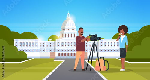 Woman journalist with reporter man presenting live