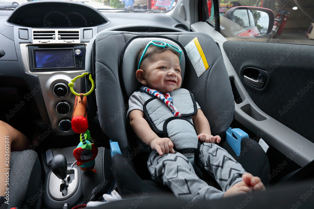 cute baby boy sitting on car seat safety belt lock protection for happy drive road trip travel in summer day cute baby boy sitting on car seat safety belt lock protection for happy drive road trip travel in summer day