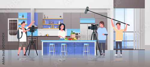 operators using video camera recording food blogger woman preparing tasty dishes videographers using professional equipment cooking blog film production concept kitchen interior horizontal