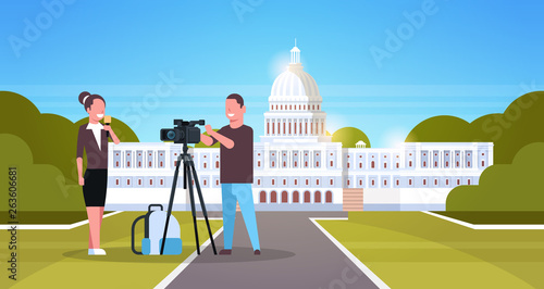woman journalist with reporter man presenting live news operator using video camera on tripod recording correspondent movie making concept horizontal senate white house washington ds background