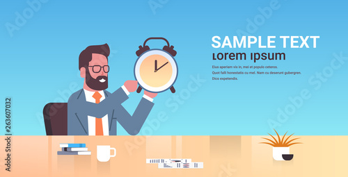 happy businessman holding alarm antique clock business man sitting workplace desk deadline time management concept male cartoon character portrait flat copy space