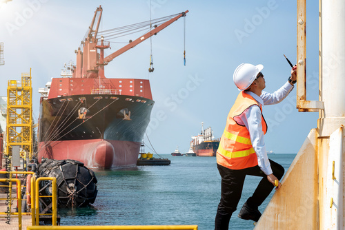 port control, harbour master, engineering or worker in duty of working in charge climbing to the station takes control ship loading in port, working in high at high level of risk and insurrance
