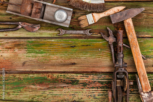 Old vintage hand tools on wooden background