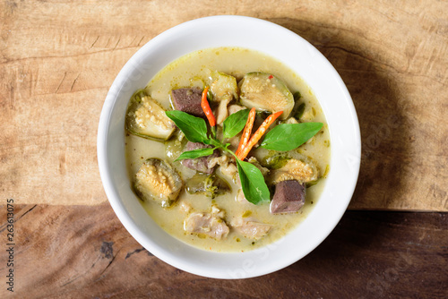 Thai green curry chicken (Kang Keaw Wan Kai) in a bowl on wooden, Thai food