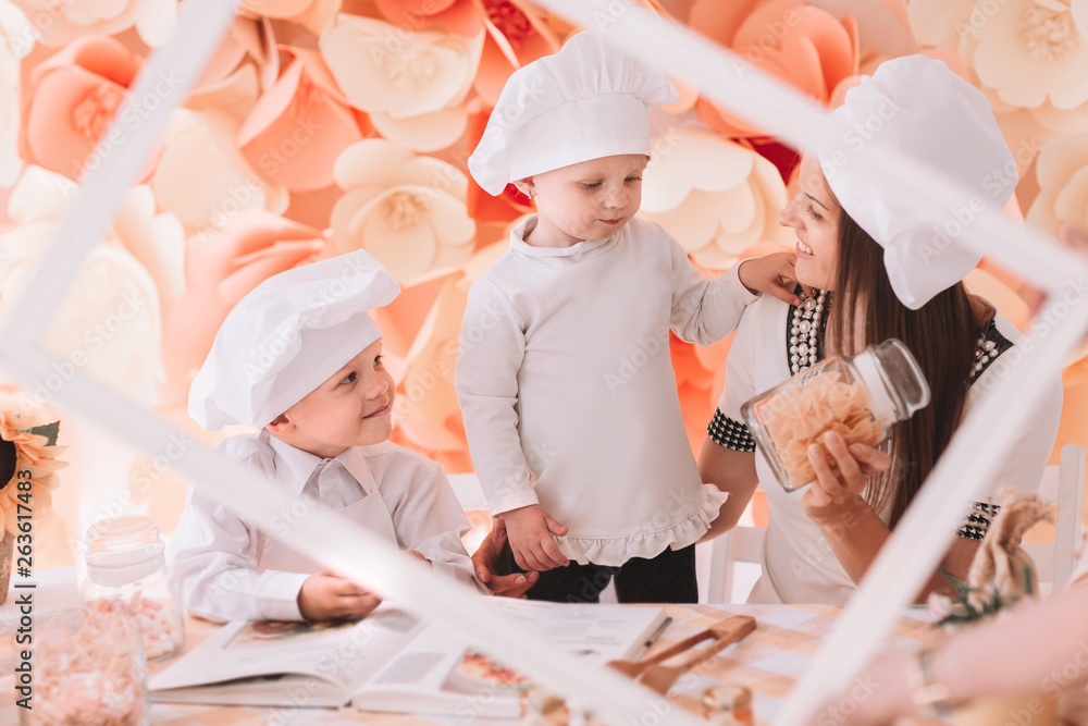 photo happy mom with children cooking in the kitchen photo happy mom with children cooking in the kitchen